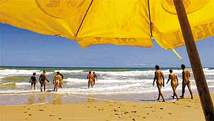 Banhistas aproveitam o mar e o sol de Massarandupi, praia no norte da Bahia que recebe diariamente 200 casais de naturistas